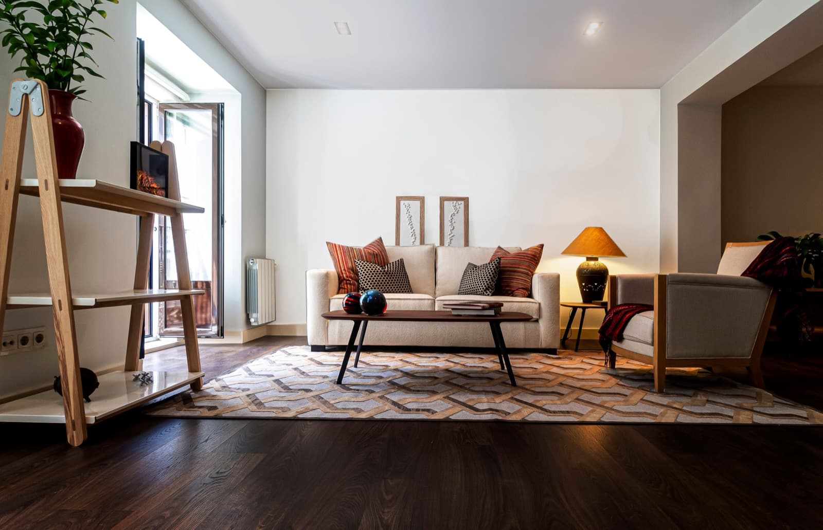 Modern living room with a beige sofa and patterned rug