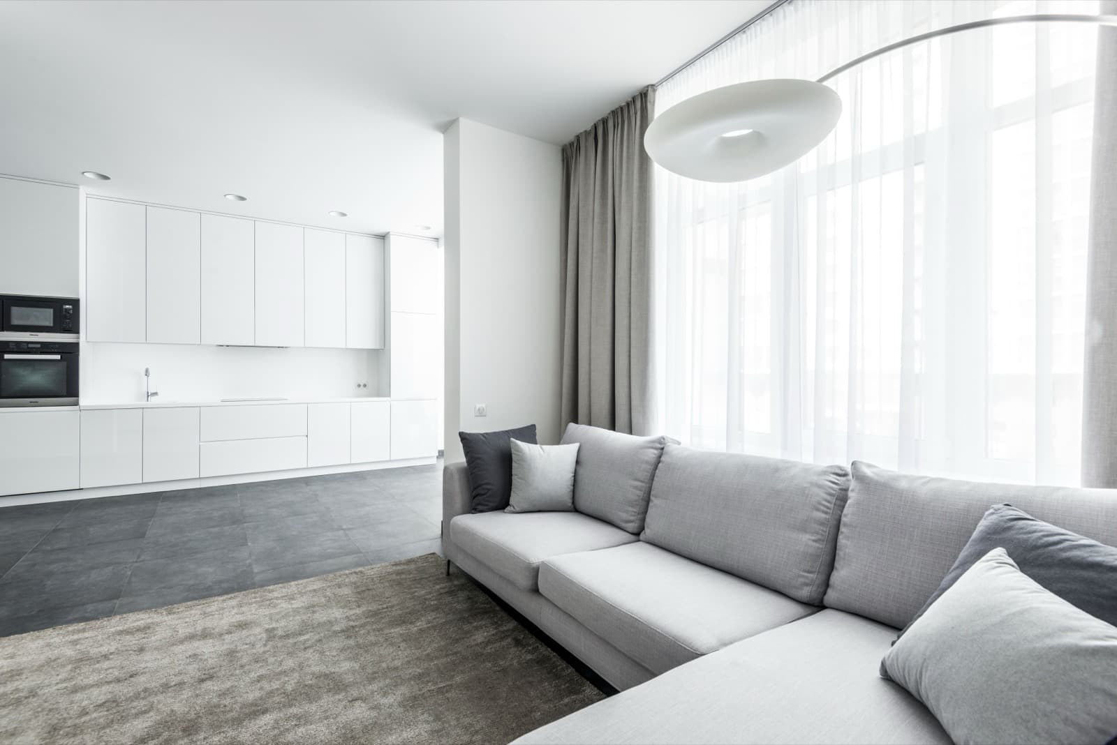 Minimalist living room with a grey sectional sofa